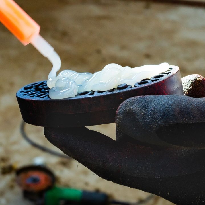  Bovi-Bond hoof block adhesive tube next to a hoof block, product mood shot. 
